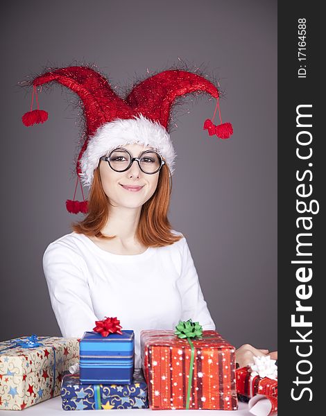 Surprised red-haired girl in christmas cap