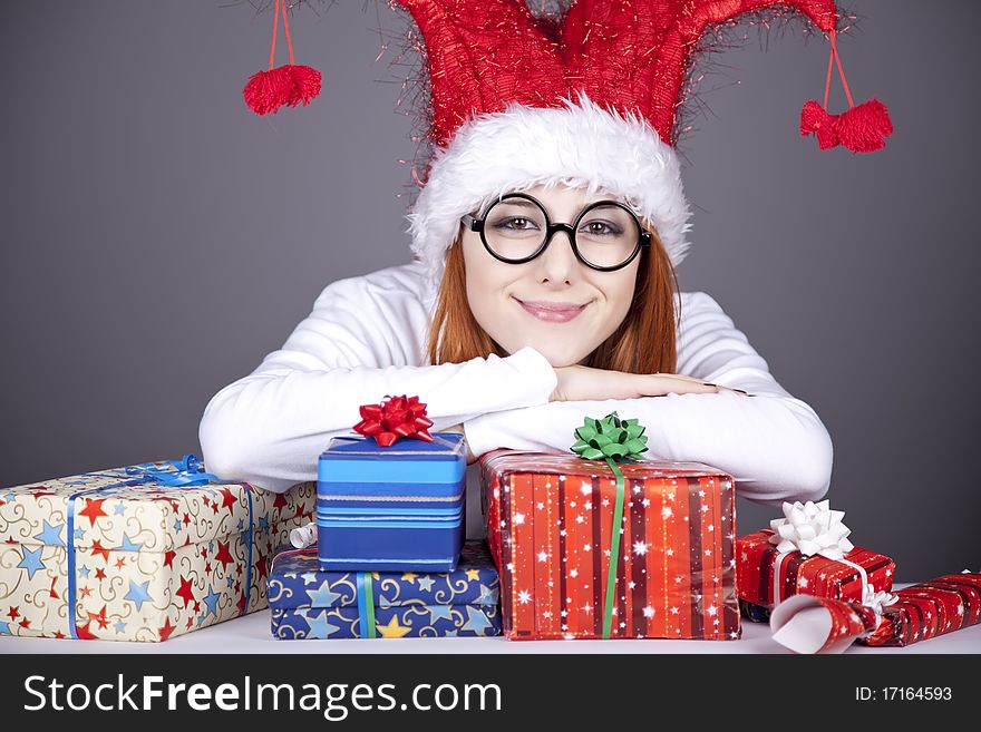 Surprised red-haired girl in christmas cap