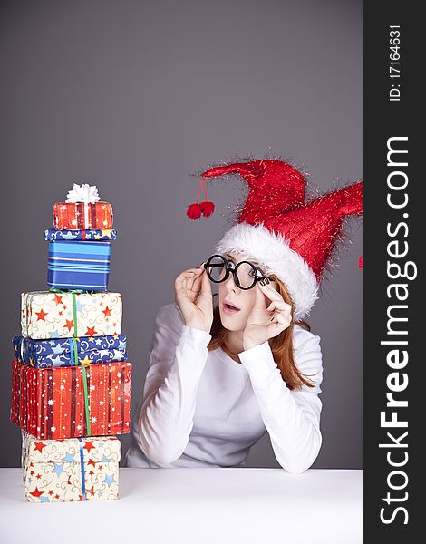 Surprised red-haired girl in christmas cap