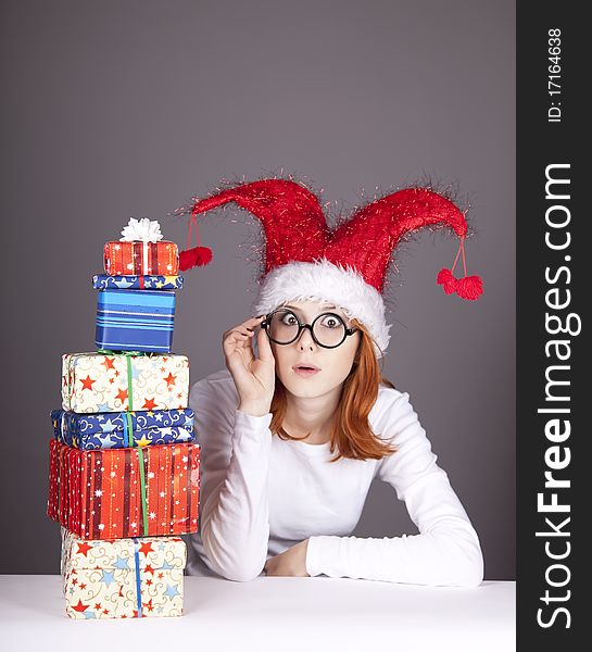 Surprised red-haired girl in christmas cap