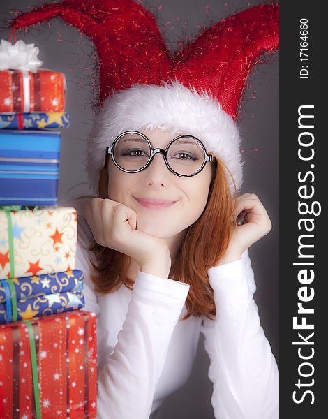 Surprised red-haired girl in christmas cap