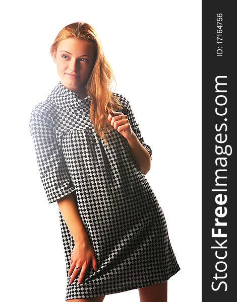 The blonde girl in a checkered dress on a white