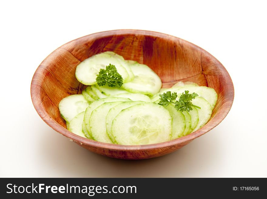 Cut cucumber and in wood bowl. Cut cucumber and in wood bowl