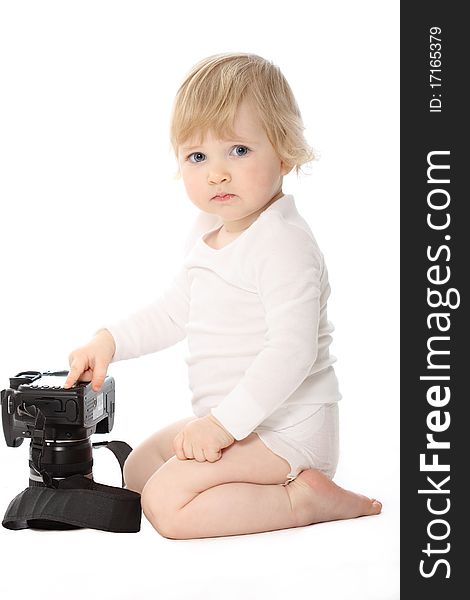 Baby dressed in white with black camera isolated on white. Baby sit looking in the squatting position. Baby dressed in white with black camera isolated on white. Baby sit looking in the squatting position