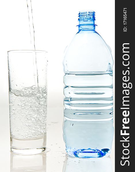 A bottle of fresh mineral water and a glass