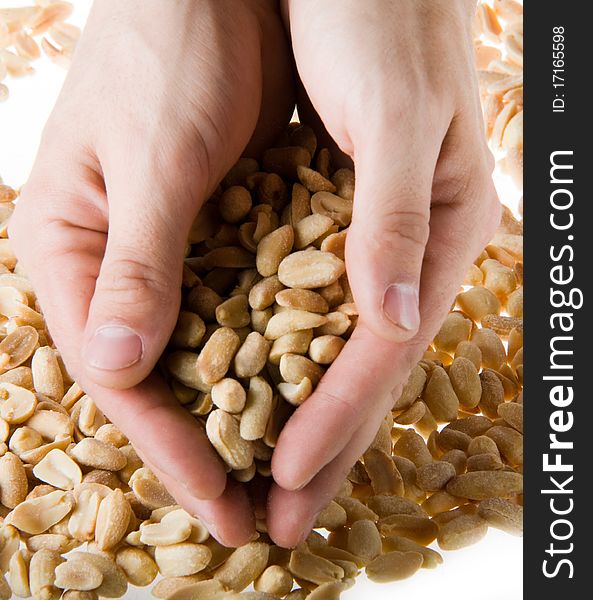 Hand holding a handful of salted peanuts on a white background 1