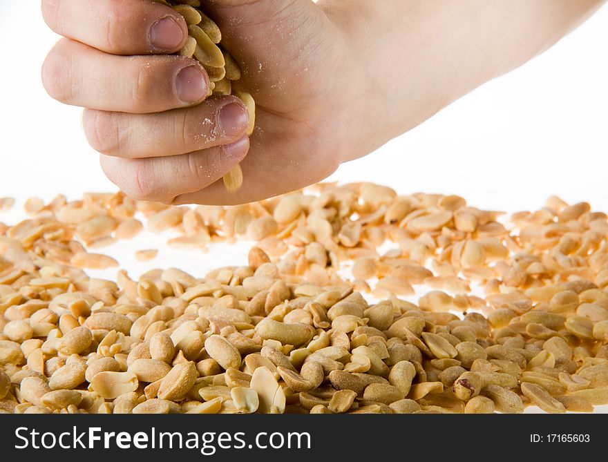 Hand holding a handful of salted peanuts on a white background 1