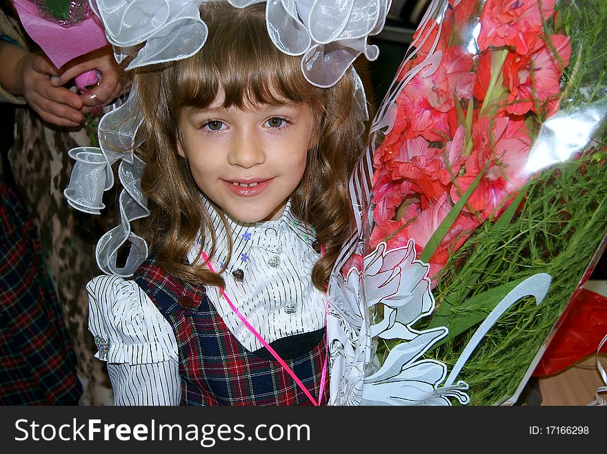 Portrait of the smiling girl of the schoolgirl on September, 1st with a bunch of flowers. Portrait of the smiling girl of the schoolgirl on September, 1st with a bunch of flowers