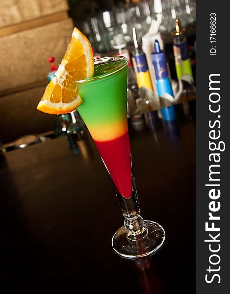 Colorful cocktail isolated on bar background, inclined perspective