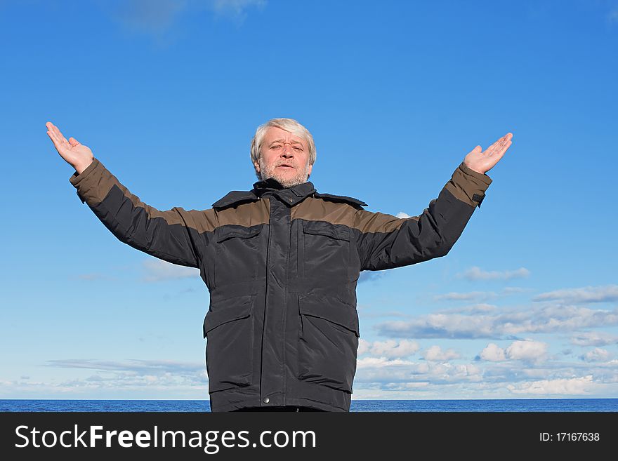 Middle-aged man on blue sky of the background.