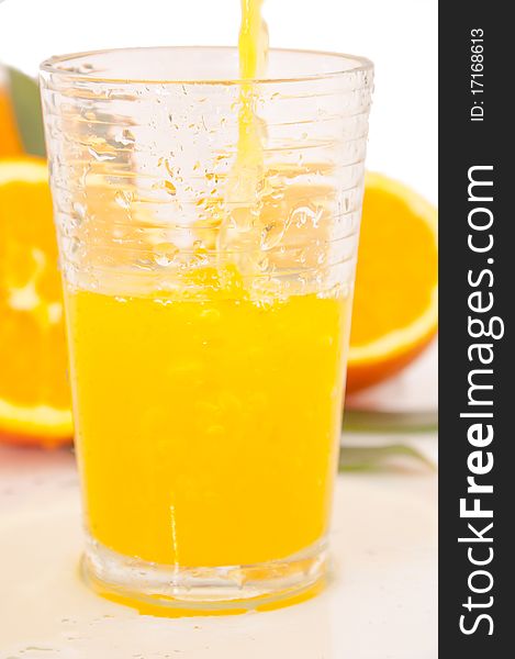 Orange juice and freshly squeezed orange