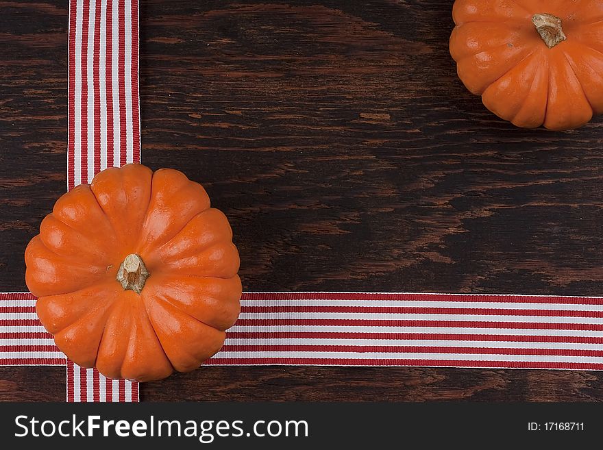 Small orange pumpkins symbolising autumn holidays and used in decorative works.