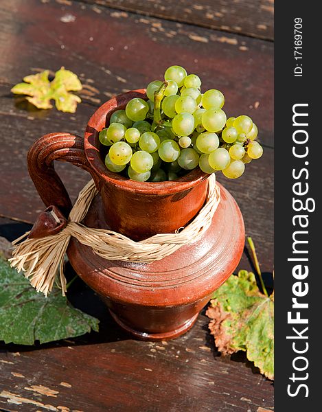 Ceramic jug with wine grape. Ceramic jug with wine grape