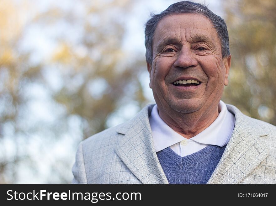 Portrait of a smiling senior man in Nature, looking at camera. Portrait of a smiling senior man in Nature, looking at camera