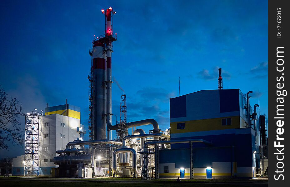 Beautiful scenic of petrochemical oil refinery plant shines with red and white lights at night.