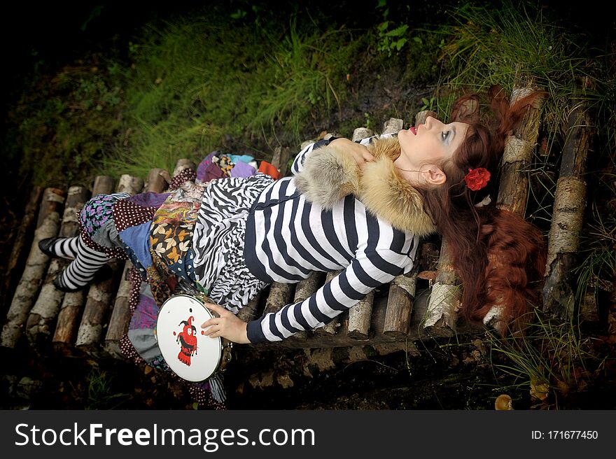 Red-haired gypsy in colorful clothes, fortuneteller