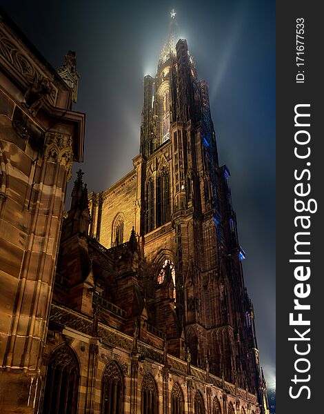 Stunning bottom view of Strasbourg Cathedral illuminated at night, Europe`s tallest building