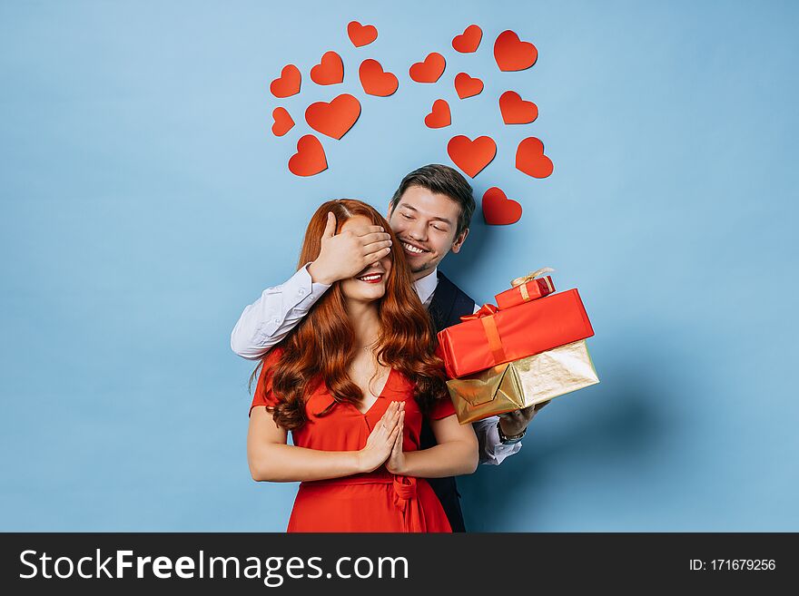 Portrait of young caucasian happy couple on the eve of valentines day, young bearded male gladden his redhaired girlfriend. love concept. Portrait of young caucasian happy couple on the eve of valentines day, young bearded male gladden his redhaired girlfriend. love concept