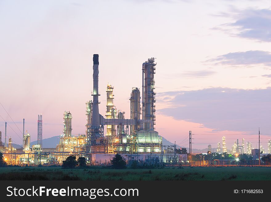 Oil refinery factory at processing work at twilight