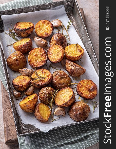 Roasted potato with rosemary on a baking sheet. Roasted potato with rosemary on a baking sheet