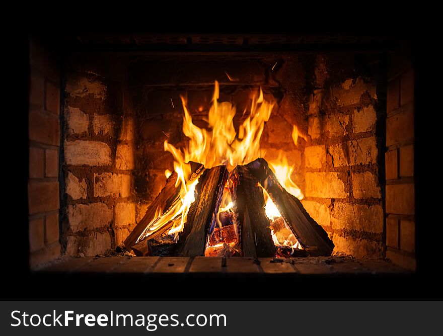 Firewood burning in a fireplace close-up