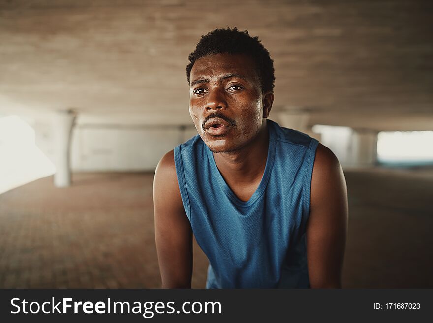 Portrait of a fit young male athlete feel fatigue taking a break after morning run