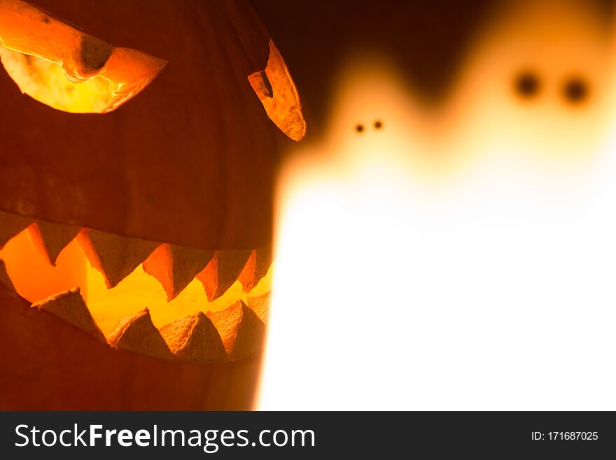 Spooky carved halloween pumpkin and creepy mystery fire ghosts