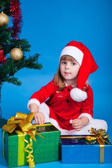 Pretty Baby Miss Santa Sitting Near Christmas Tree Stock Images