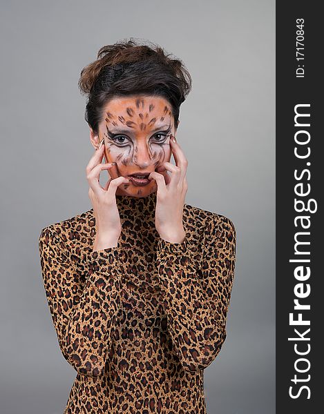 Portrait of girl with leopard's face-art in the studio