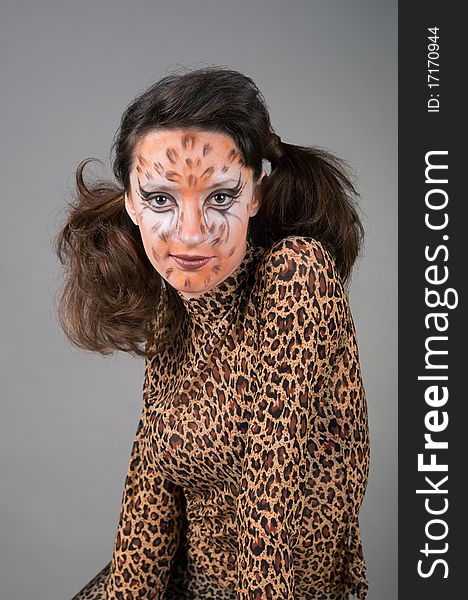 Portrait of girl with leopard's face-art in the studio