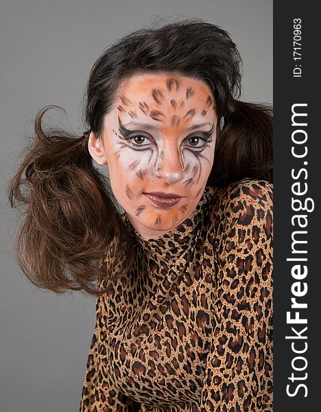 Portrait of girl with leopard's face-art in the studio
