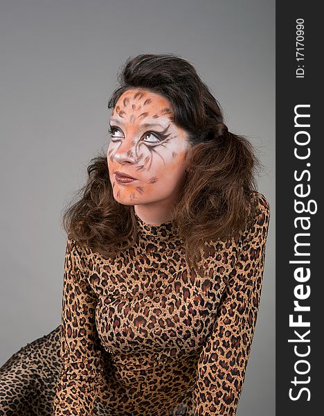 Portrait of girl with leopard's face-art in the studio