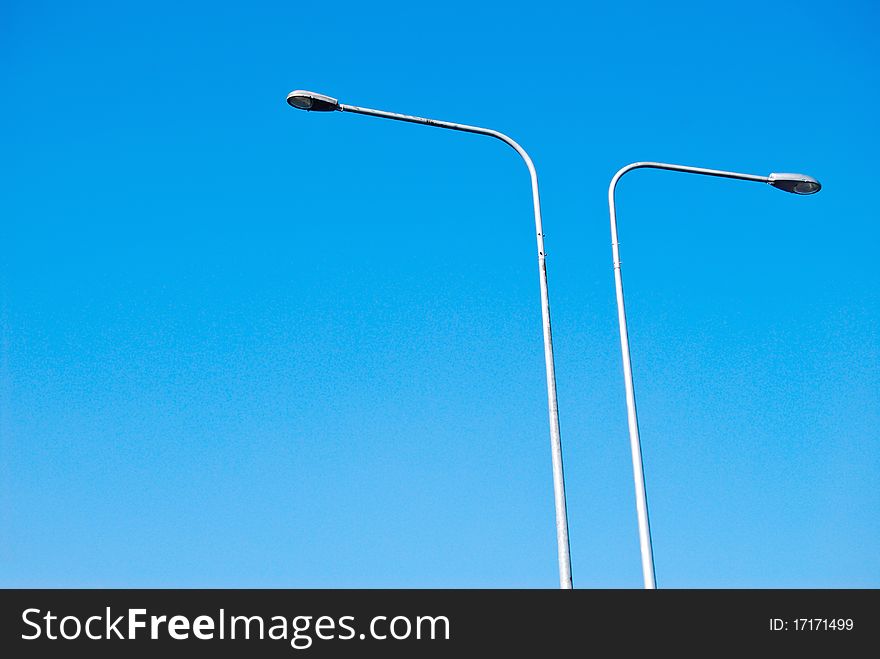 Electricity lamp post on the blue sky background