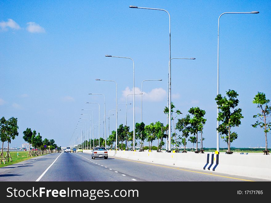 Urban roady way with electricity lamp post on the sideway. Urban roady way with electricity lamp post on the sideway