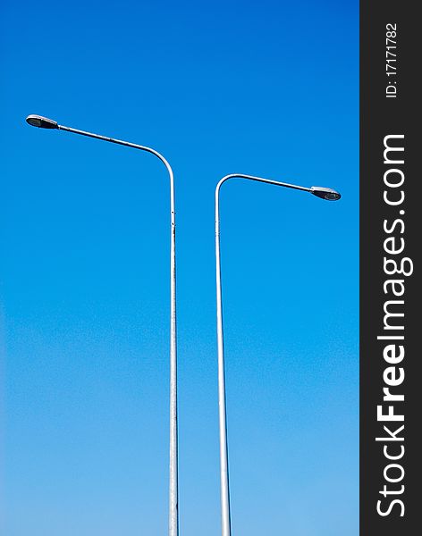 Electricity lamp post on the blue sky background