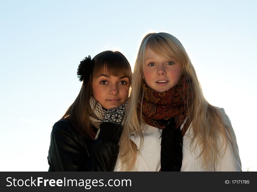 Two young beautiful girls on snow landscape