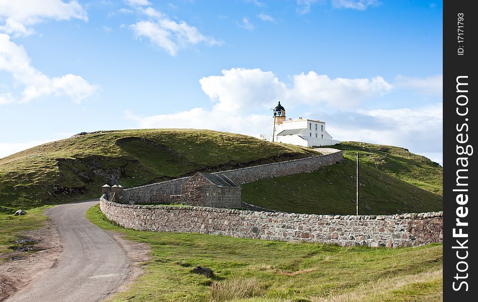 Tipical panorama of Scotland, with a lighthouse and blue sky. Tipical panorama of Scotland, with a lighthouse and blue sky
