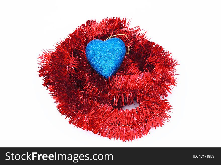 Christmas decorations for Christmas trees. Red tinsel and blue heart. Christmas decorations for Christmas trees. Red tinsel and blue heart.