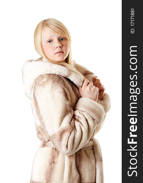 A beautiful young girl in a fur coat on a white background