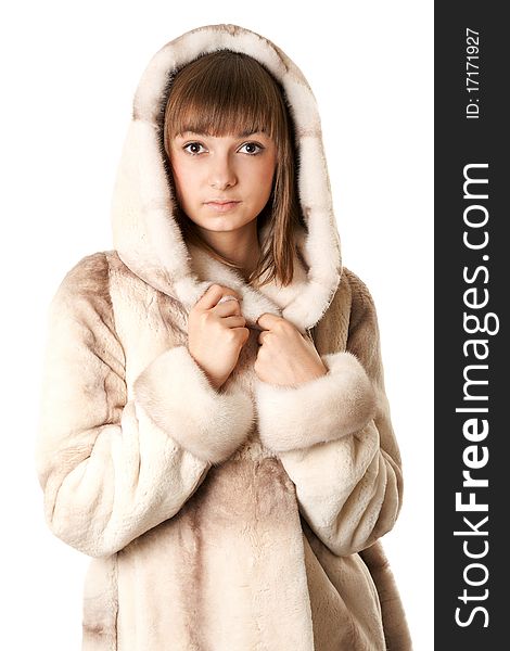 A beautiful young girl in a fur coat