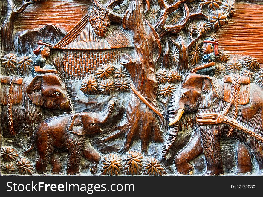 Farmer and elephant wood carving background