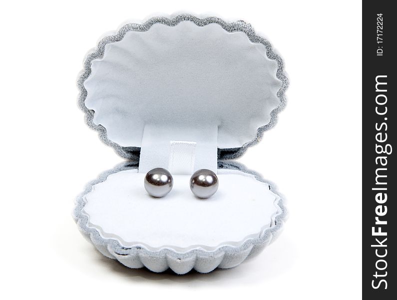 Earrings in small box and necklace on white background