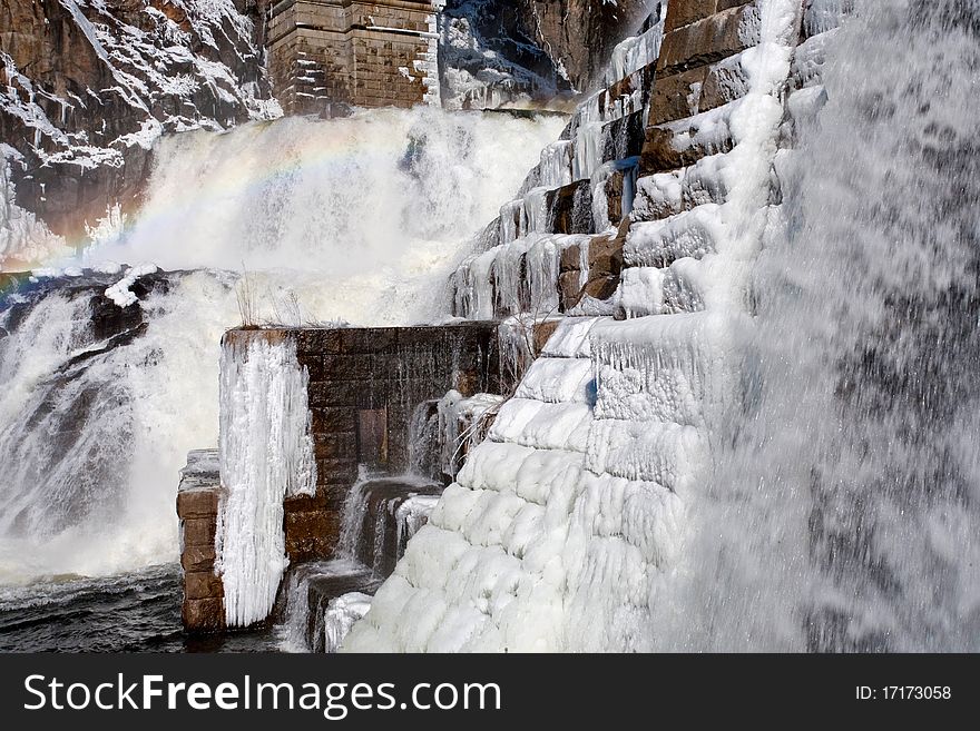 Rainbow on frozen water cascade. Rainbow on frozen water cascade