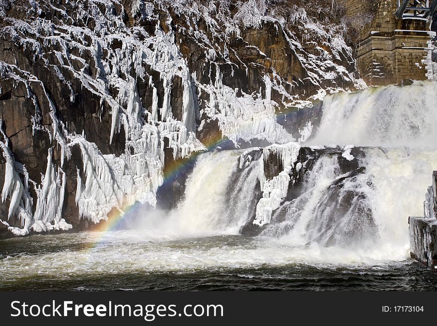 Rainbow on frozrn water cascade. Rainbow on frozrn water cascade