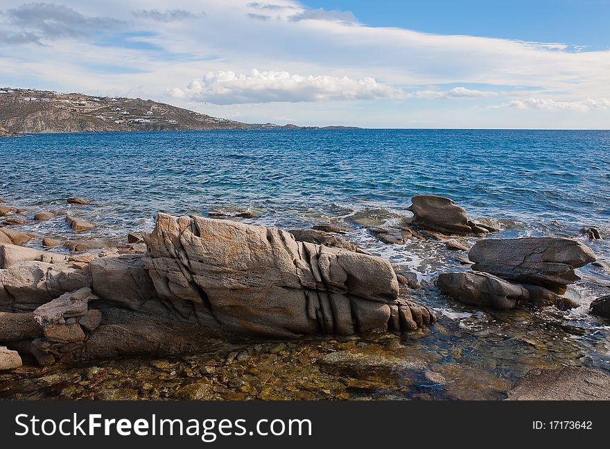 Rocks and stones at the blue sea in the surf ... Greece.