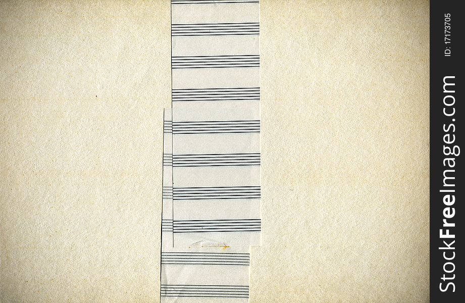 Pack of old yellowed paper, tightly laced tape made from a music paper