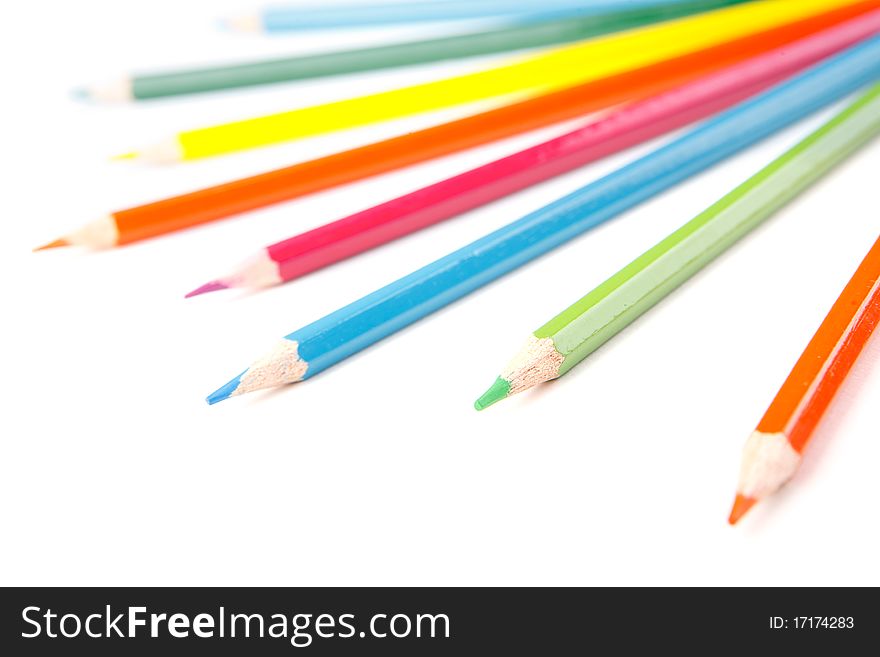 A lot of colored pencils on white background. A lot of colored pencils on white background