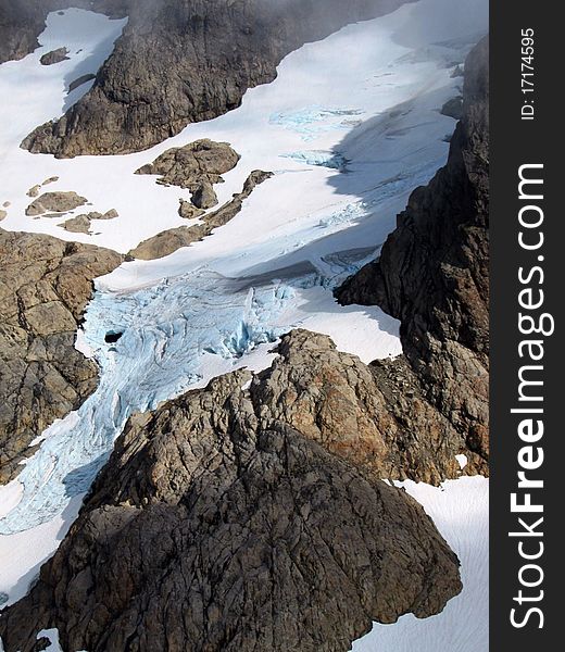 The Queest-alb Glacier in the Cascade Mountains of Washington state. It features old blue ice with many fissures and crevasses. The Queest-alb Glacier in the Cascade Mountains of Washington state. It features old blue ice with many fissures and crevasses.