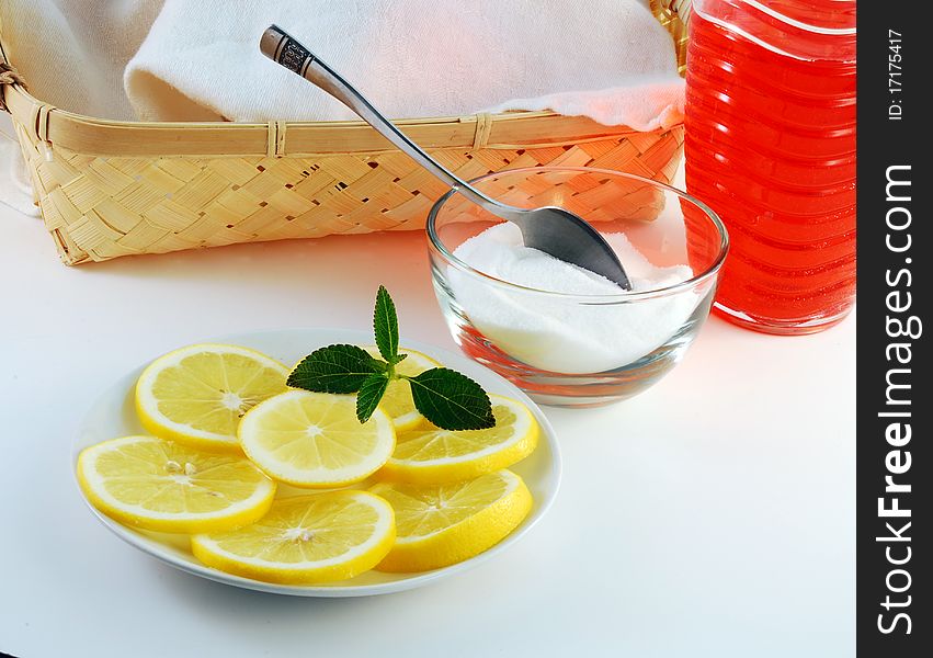 Cherry juice in a glass with a lemon on a white background. Cherry juice in a glass with a lemon on a white background