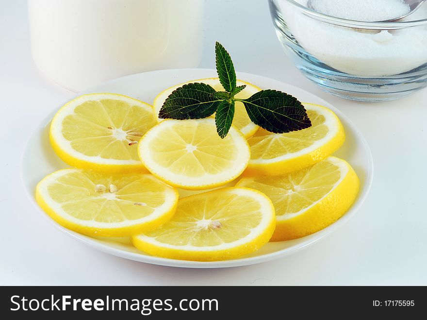 Cherry juice in a glass with a lemon on a white background. Cherry juice in a glass with a lemon on a white background